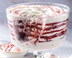 a red and white layered dessert in a glass dish