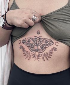 a woman with a butterfly tattoo on her stomach