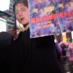 a person holding up a book in front of their face