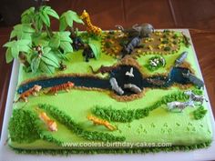 a birthday cake with animals and plants on it