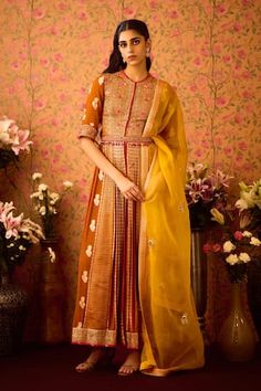 Amber mustard yellow pleated anarkali with scattered woven floral motifs and floral zardozi hand embroidery. Paired with a pant and coordinating belt. Comes along with a dupatta with scattered butti embroidery. - Aza Fashions Yellow Slub Silk Churidar For Festivals, Yellow Anarkali Chanderi Palazzo Set, Yellow Slub Silk Anarkali Set With Dupatta, Yellow Slub Silk Anarkali Set With Pallu, Yellow Cotton Silk Anarkali Set With Cutdana, Traditional Yellow Slub Silk Anarkali Set, Yellow Cotton Silk Anarkali Set For Wedding, Yellow Silk Churidar With Gota Work, Yellow Art Silk Anarkali Set With Chikankari Embroidery