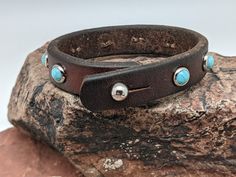 Turquoise (faux) stones are set into this leather bracelet. Wear it as one piece but better yet, layer, layer, layer! The leather is from retired horse tack that has been cleaned, reconditioned and given new life. Note: Leather will vary based upon what is in stock Adjustable Turquoise Leather Bracelet In Rustic Style, Southwestern Adjustable Brown Leather Bracelet, Adjustable Rustic Turquoise Leather Bracelet, Adjustable Turquoise Leather Bracelet Southwestern Style, Adjustable Turquoise Leather Bracelet In Southwestern Style, Adjustable Turquoise Leather Bracelet With Concho, Adjustable Turquoise Cuff Bracelet With Concho, Adjustable Turquoise Western Bracelet, Southwestern Adjustable Leather Cuff Bracelet