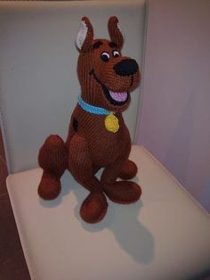 a stuffed dog sitting on top of a toilet seat