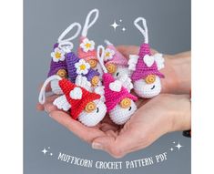 small crocheted toys in the palm of someone's hand with stars on them