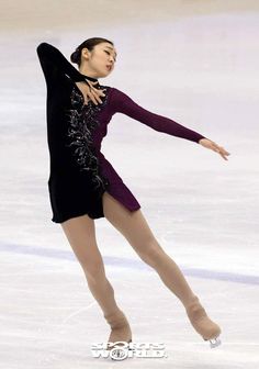 a female figure skating on an ice rink