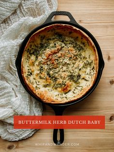 buttermilk herb dutch baby in a cast iron skillet on a wooden table