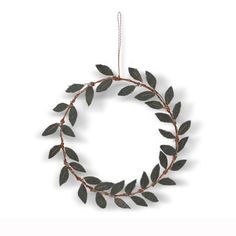 a metal wreath with leaves hanging from it