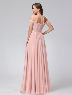 a woman in a long pink dress with off the shoulder sleeves and lace detailing on it