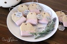 some tea bags are sitting on a plate with lavender flowers and tags attached to them