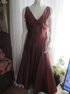 "1990's sleeveless, deep-V front/back bronze/dark brown cocktail dress, by Nicole Miller of New York, in a size 6. Dress has a big flared circle skirt, with attached under slip of silk/netting, back nylon zipper, outer dress fabric is silk. Front bodice is in a deep-V cleavage in a large bust bow look, as well as a deep-V bodice back. Dress is in great condition, Bust 32 1/2\", Waist 28\". PRICE IS $179.00------SALE FINAL/AS IS/NO RETURNS." Sleeveless Silk Brown Dress, Sleeveless Brown Evening Dress, Brown Sleeveless Evening Dress, Brown Cocktail Dress, Brown Cocktail, Outer Dress, Brown Flares, Flowing Dresses, Nicole Miller