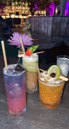 three different types of drinks on a table