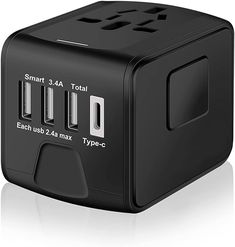 an image of a black travel charger with three usbs on the front and side