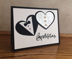 a close up of a card with two hearts on it and the words congratulations written in black