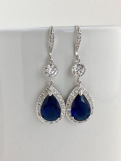 a pair of blue and white crystal earrings