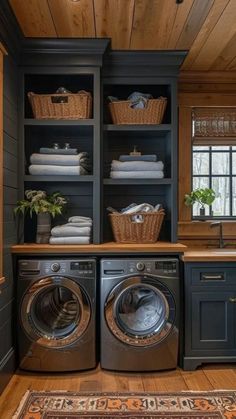 a washer and dryer in a room with wooden floors, cabinets and drawers