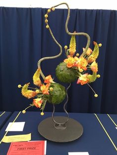 a table that has some kind of art on it with flowers in the center and other decorations