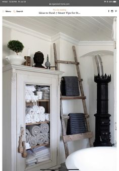 a bathroom with a ladder leaning up against the wall