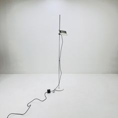 a light that is on top of a white floor next to a black and white lamp