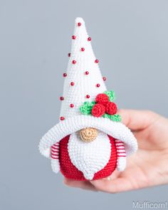 a hand holding a crocheted christmas ornament