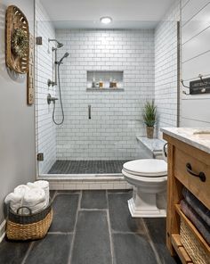 a bathroom with a walk in shower next to a toilet