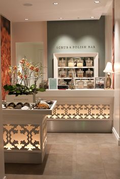 the inside of a store with flowers and food on display in it's windows