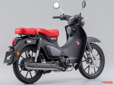 a black and red scooter is shown on a gray background