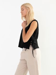 "AVERY is a linen tank top with side ties. DETAILS - Sleeveless design - Crew Neck - Side Ties - Straight cut - 100% lightweight European linen fabric - Cut and sewn to order just for you in our studio COLOR - Black, you can also choose other colors above - Fabric samples are available here https://www.etsy.com/listing/586569696/linen-fabric-samples SIZING & FIT - Fits true to size - Length is approximately 19 inches / 48 cm - Bust is approximately 19 inches / 48 cm - Measurements taken from Black Linen Spring Vest, Sleeveless Tops With Drawstring Tie, Black Sleeveless Linen Vest, Casual Spring Tops With Side Ties, Casual Tops With Side Ties For Spring, Casual Linen Tops With Tie Straps, Black Sleeveless Top With Drawstring, Black Linen Sleeveless Tank Top, Chic Black Linen Tank Top