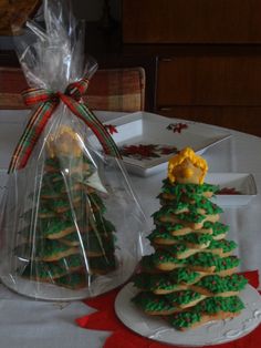 two christmas trees made out of cookies sitting on top of a table next to each other