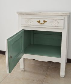 a small white cabinet with an open door on the bottom and one drawer at the top