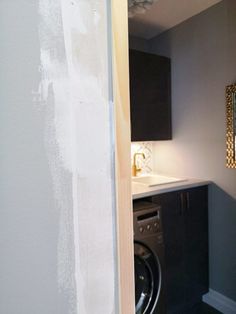 a washer and dryer are in the corner of a room that is being remodeled