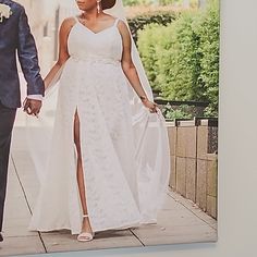 a bride and groom are walking down the street holding each other's hands,