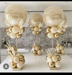 some balloons are sitting on a table in front of a wall with gold foil decorations