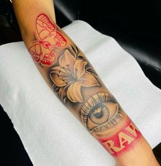 a woman's arm with an eye and flowers on it