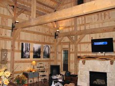 a living room filled with furniture and a flat screen tv mounted to the side of a wall