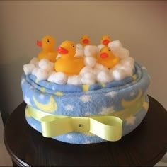 there is a cake that has rubber ducks in the bathtub on top of it