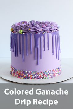 a cake with purple icing and sprinkles sitting on top of a white plate