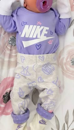 a baby doll wearing a nike shirt and pants