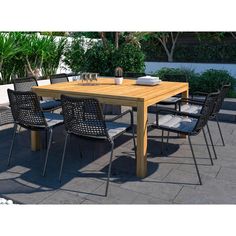 an outdoor dining table and chairs on a patio