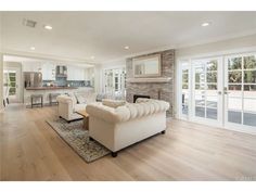 a living room filled with furniture and lots of windows on top of it's walls