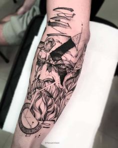 a man's arm with a black and white tattoo design on the left forearm