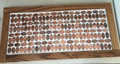 a close up of a wooden board with many different types of penny coins on it