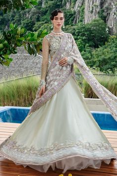 Luxury Embroidered Mint Green Pakistani Wedding Wear Lehenga Choli comes alive with scintillating florals, and iridescent details accentuate the composed blouse with zari tissue lehnga embellished at the bottom. Hand-placed sequins, crystals, and seed pearls add a touch of glamour to the silver, gold and silk thread-worked blooms. Embroidered Choli: The beautiful Choli in the alluring Mint Green shade having long sleeves is heavily emblazoned with gotta, zari, naqshi, beads, crystals, and sheesh Choli Dress, Couture Bridal, Wedding Lehenga, Pakistani Wedding, How To Dye Fabric, Silk Thread, Bridal Couture, Embellished Dress, Wedding Wear