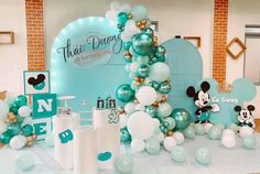 a table with balloons and mickey mouse decorations