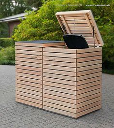 a large wooden box sitting on top of a sidewalk