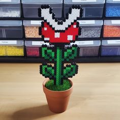 a plant made out of legos sitting on top of a table