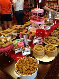 a table filled with lots of different types of desserts and pastries on plates