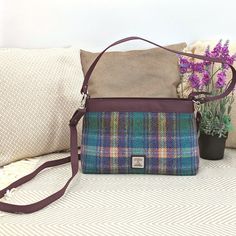 Our Harris Tweed Large Shoulder Bag is a brilliant size with a durable style, that can be used every day. The shoulder bag has one main compartment, secured with a zip. Inside this Harris Tweed bag there are open pockets for phones and essentials as well as a small zip compartment. This bag has a short shoulder strap as well as a longer detachable strap that you can wear across your body. Large Shoulder Bag Dimensions: 20cm x 30cm x 9cm The vegan leather trim colour will differ depending on the Tweed Bag With Detachable Strap, Rectangular Shape, Rectangular Tweed Bag With Detachable Strap, Rectangular Tweed Shoulder Bag For Travel, Rectangular Tweed Shoulder Bag For Everyday Use, Rectangular Tweed Shoulder Bag For Everyday, Rectangular Tweed Bag For Daily Use, Rectangular Tweed Bags For Daily Use, Everyday Tweed Crossbody Bag, Harris Tweed Bag