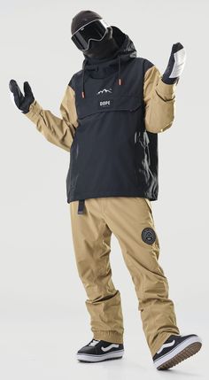 a man in ski gear is standing with his hands up