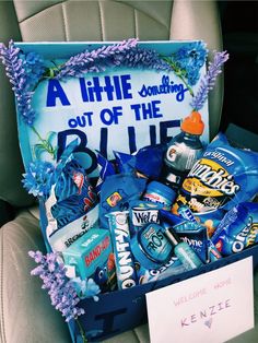 a car seat with a sign and some snacks in it