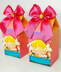 two small boxes with pink bows on the front and one has an orange box in the middle